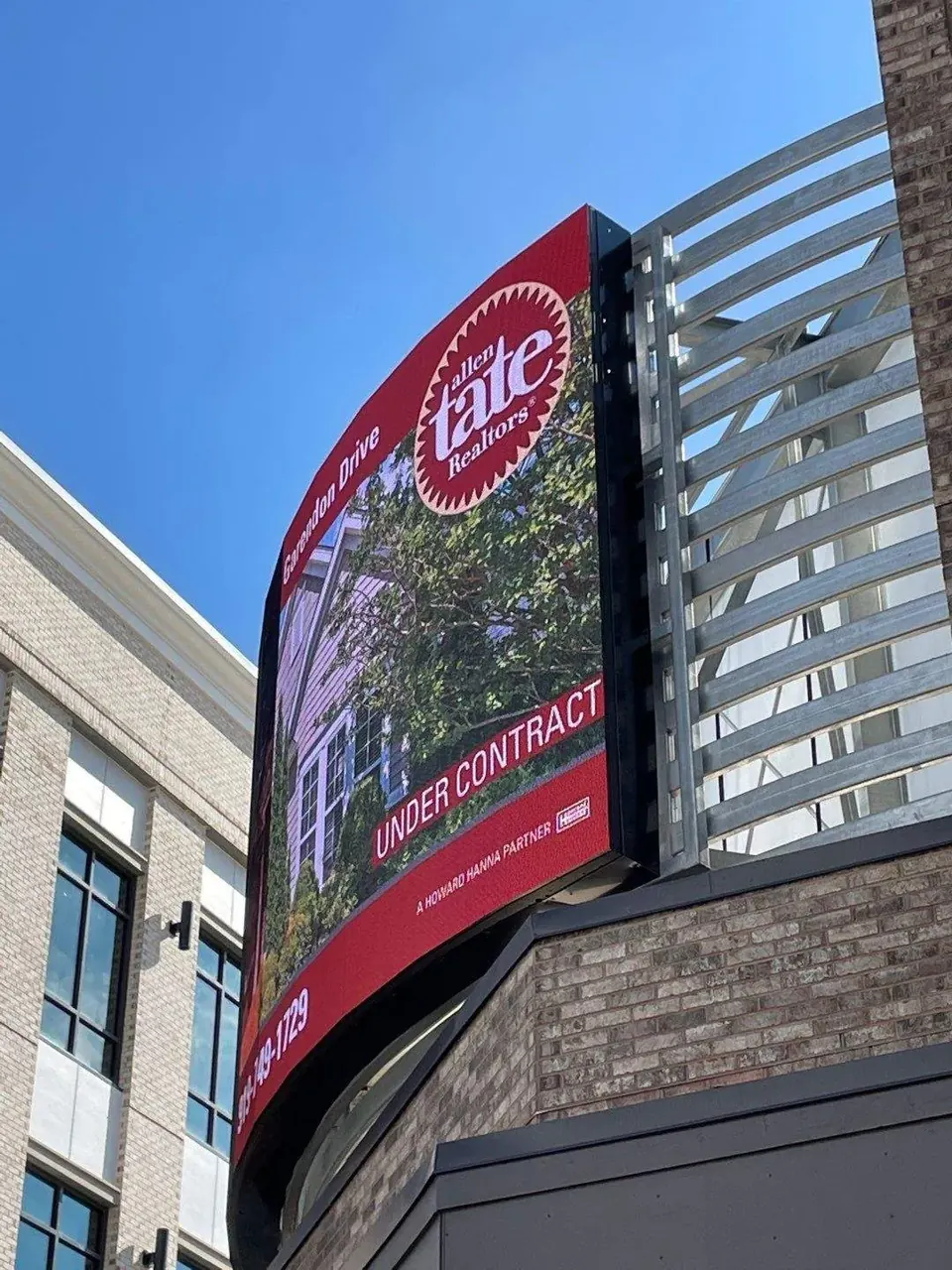 Curved outdoor LED display mounted to a building exterior