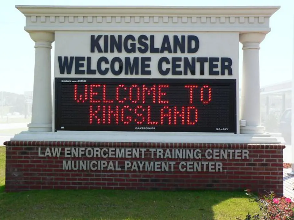 Outdoor electronic message center beneath Kingsland Welcome Center lettering
